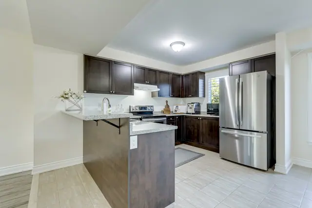 Kitchen with breakfast bar and stainless steel appliances